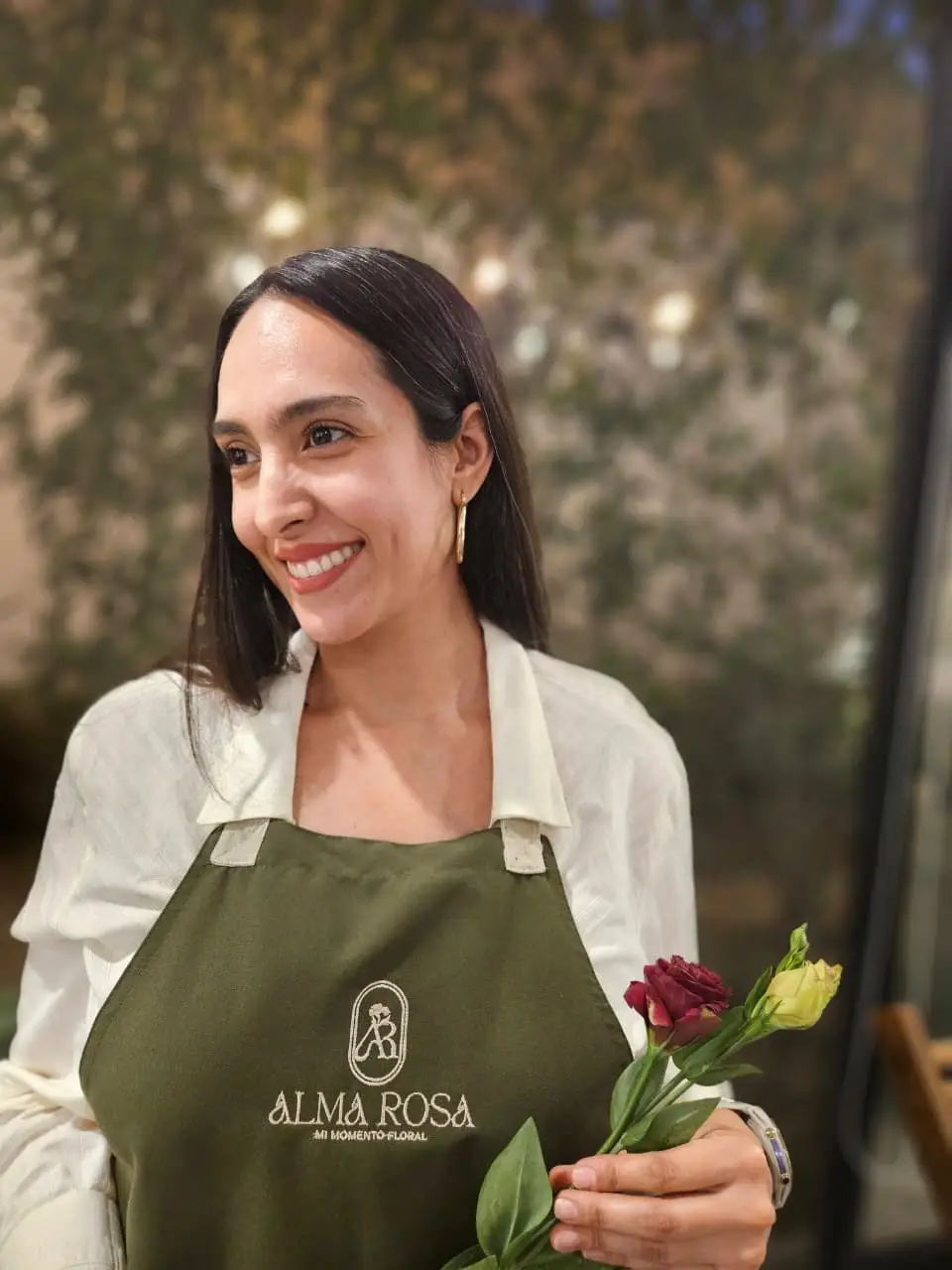 Liz, fundadora de Alma Rosa, riendo con su mandil de trabajo